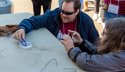 Person giving a physics demonstration.