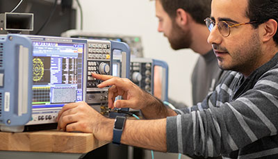 Engineering student at a piece of equipment. 