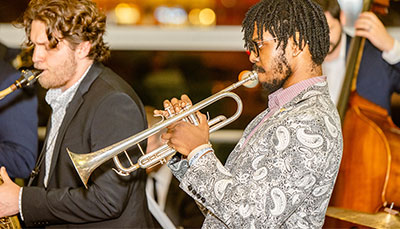 Jazz student playing in a band on stage. 