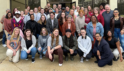 Large group of student posed together outside. 